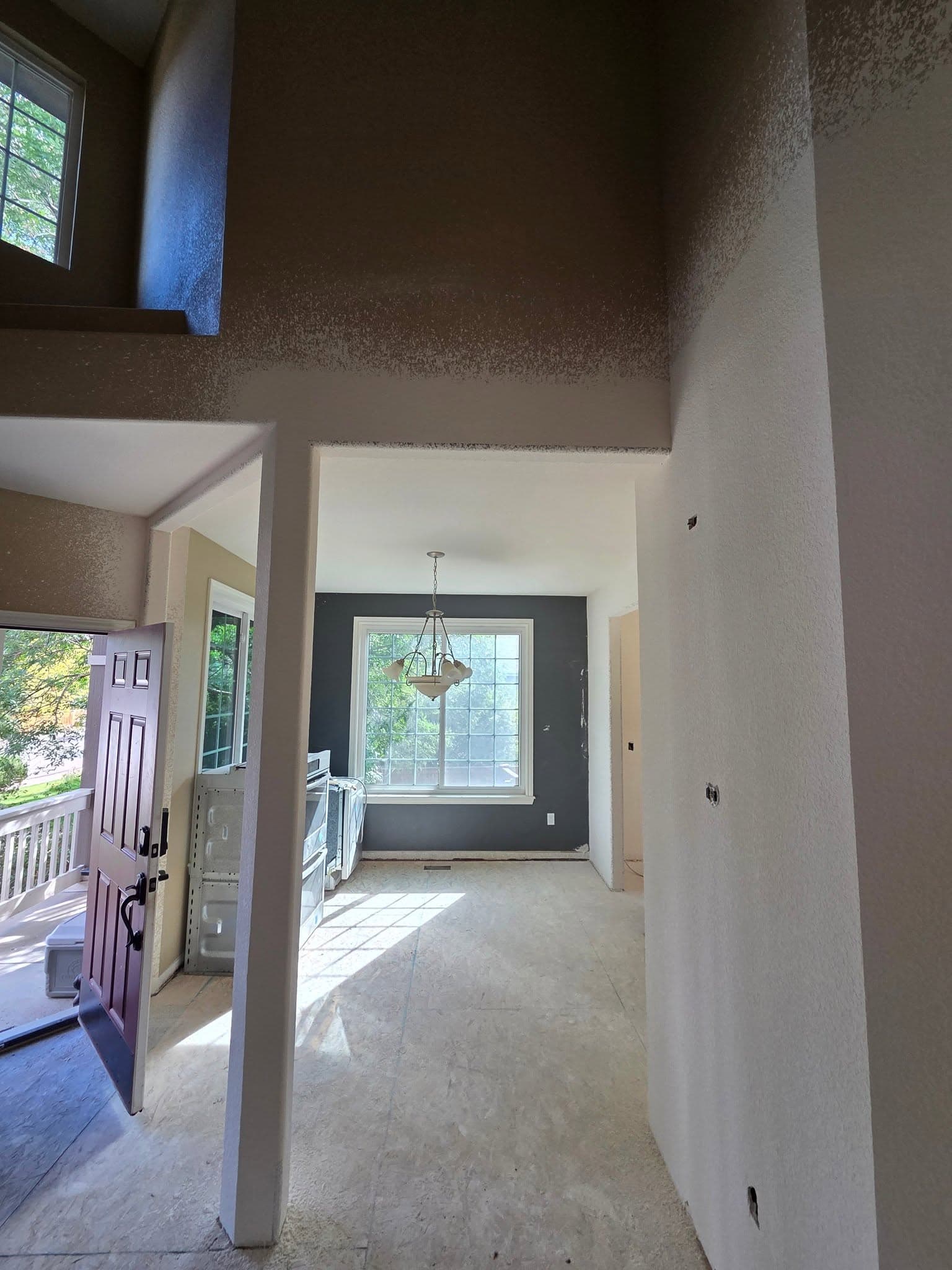 Bright entryway showing a complete interior drywall renovation