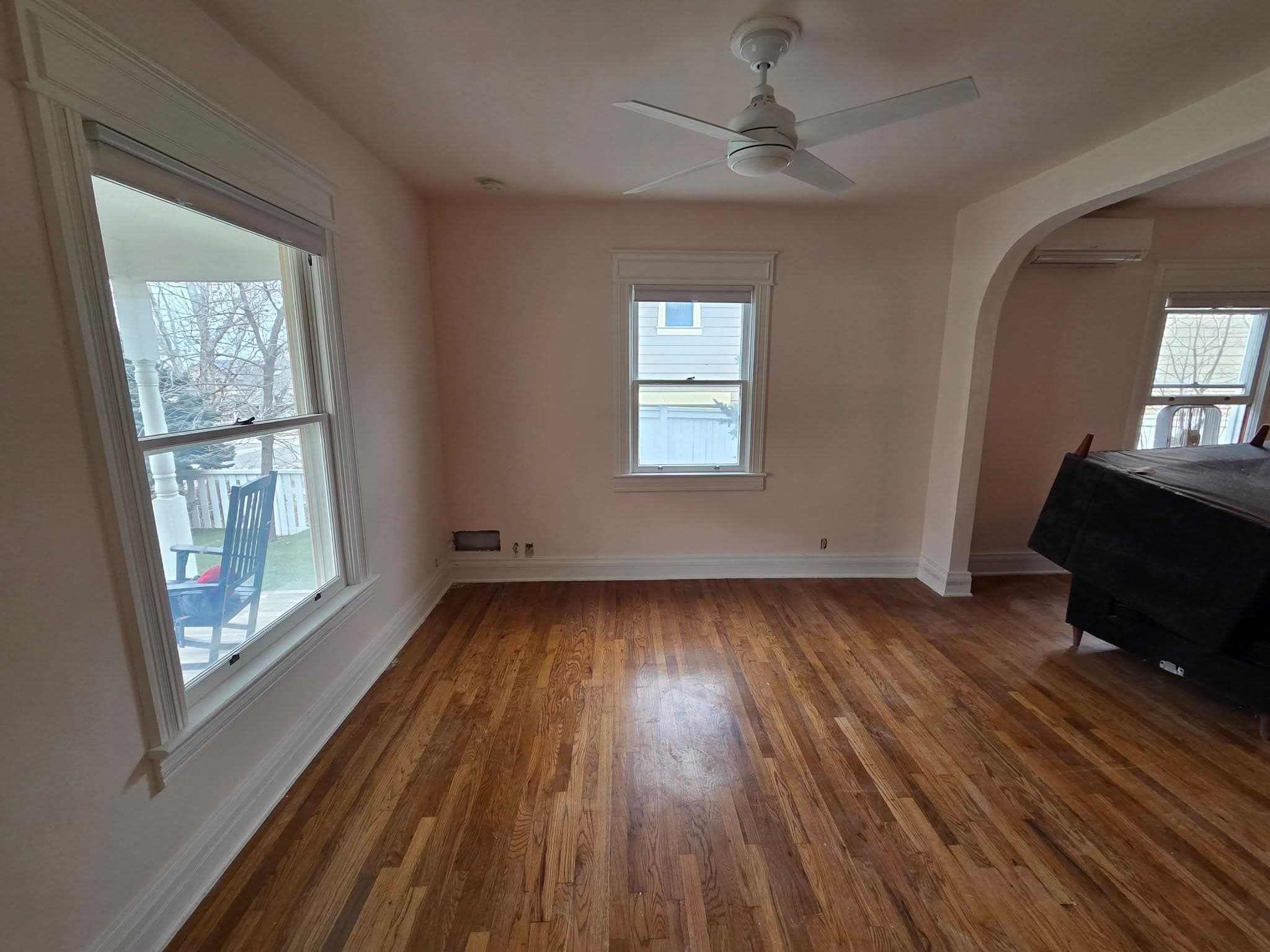 Finished residential room with hardwood flooring